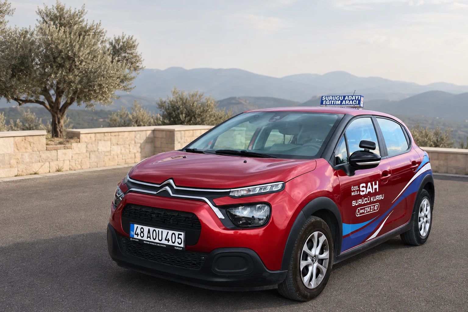 A red Citroen driver-training car from Şah Driving School